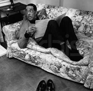 The American jazz pianist and composer Duke Ellington (1899-1974) relaxes at home as he examines some sheet music. 1963